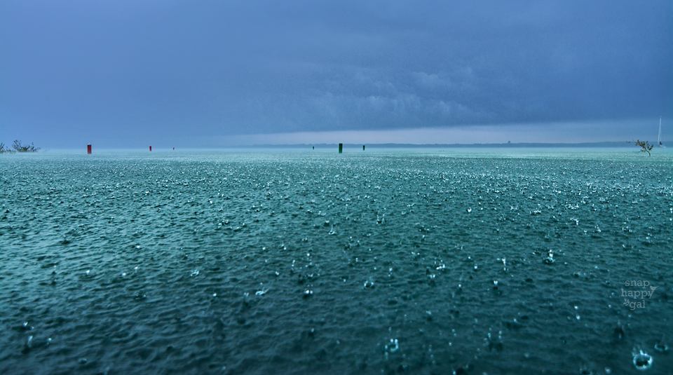 Photo: Large raindrops splash in Lake Michigan's blue waters after a summer storm's arrival